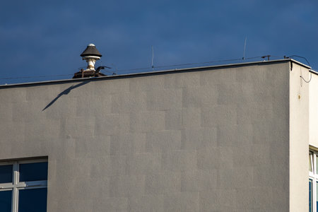 An alarm siren mounted on the roof of a buildingの写真素材