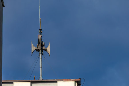 An alarm siren mounted on the roof of a building, the siren emits a signal warning of an air raid in Polandの写真素材