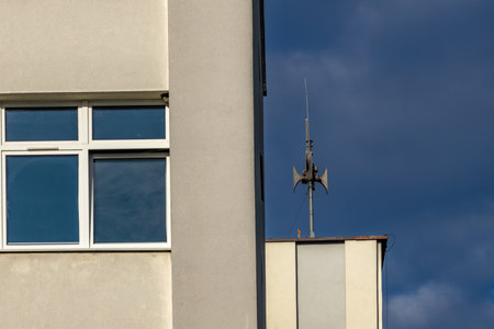 An alarm siren mounted on the roof of a building, the siren emits a signal warning of an air raid in Polandの写真素材