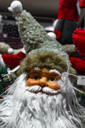 Close-up of decorative Santa Claus figurines with white beards and furry hats. Festive Christmas...