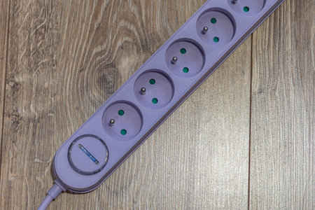 Purple extension cord with fuse placed on the ground