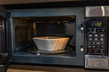 Open microwave, preparing a quick meal for dinnerの写真素材
