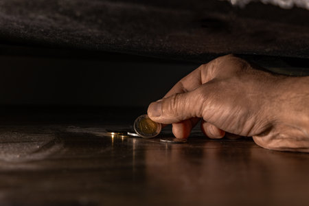 Taking money out from under the couch, looking for lost money under the couch, tidying up the house,の写真素材