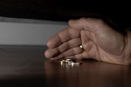 Taking money out from under the couch, looking for lost money under the couch, tidying up the house,の写真素材