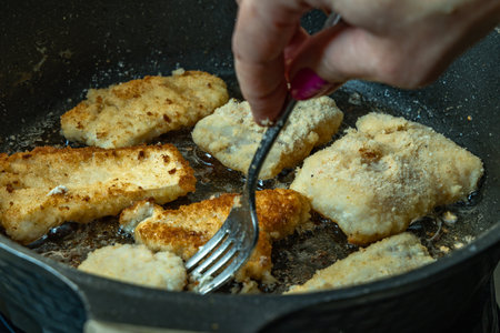 Fried cod, carp, in a glass ovenproof dish, sliced fish fried in deep oil, realistic photo