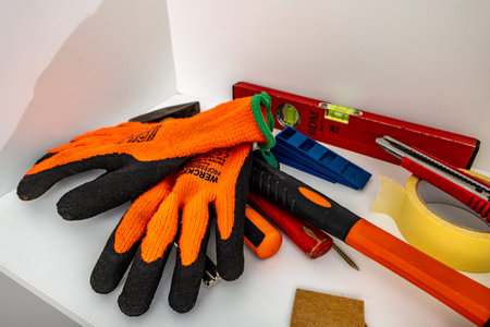 Carpentry tools, protective gloves, hammer, spirit level, screwdriver, tape measure, pencil, screws...