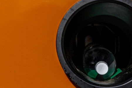 A used plastic drink bottle inserted into a slot in a bottle vending machine, return of used...
