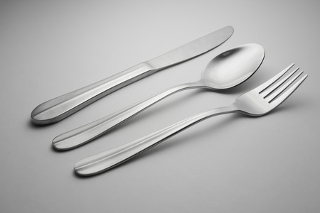 spoon, knife and fork on a white background