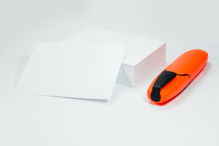 A stack of white paper with a felt-tip pen