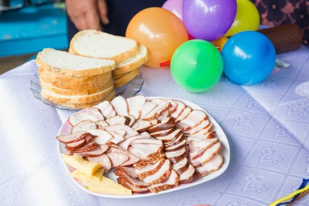Meat on a plate with bread and colored inflatable balls