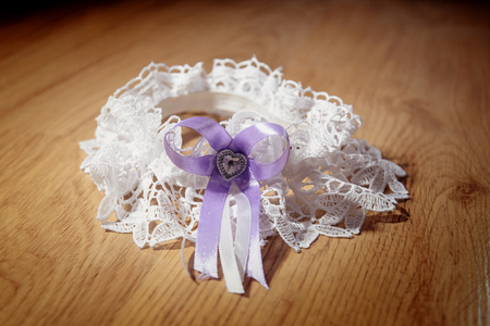 A white wedding garter for the bride lying on the floorの写真素材