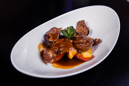Duck liver with berry sauce and apples decorated with rosemary.の写真素材