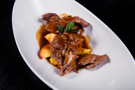 Duck liver with berry sauce and apples decorated with rosemary.の写真素材