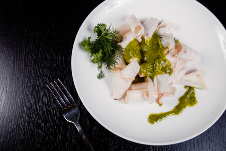 Lard. Strips of fat with copy space. Dry lard with herbs. Fat from the abdomen of a pig that is rendered and clarified for use in cooking or appetizer. Pork fat slices on a wooden plate, copy spaceの写真素材