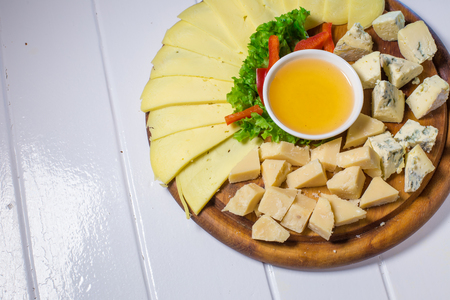 different cheese, honey and vegetablesの写真素材