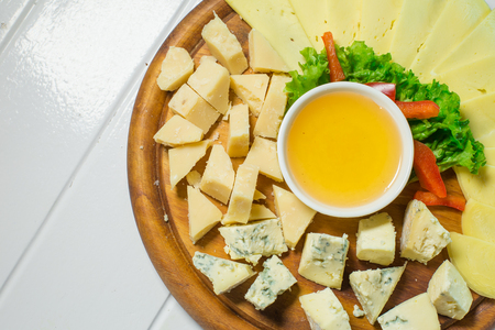 different cheese, honey and vegetablesの写真素材