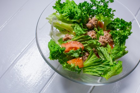 Salad with meat, chicken, lettuce, dill, tomato on white wood background. For the menu restaurant bar cafeの写真素材