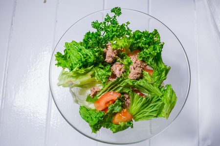 Salad with meat, chicken, lettuce, dill, tomato on white wood background. For the menu restaurant bar cafeの写真素材