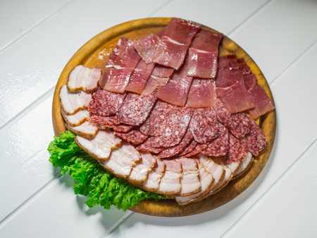 Meat plate set with salami, bacon, hamon on a white backgroundの写真素材