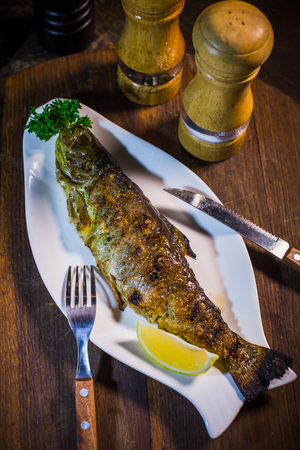 Mackerel baked with lemon. On a wood backgroundの写真素材
