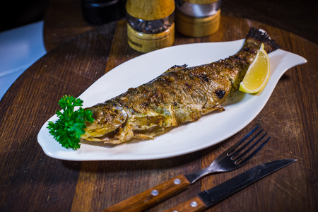 Mackerel baked with lemon. On a wood backgroundの写真素材