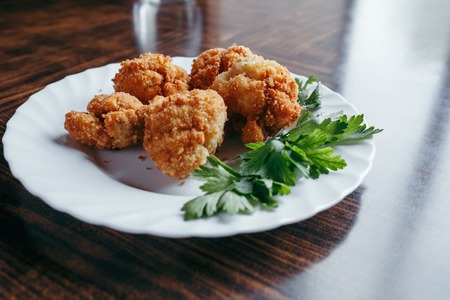 fried fresh cauliflower in breadcrumbs closeup on a plate. Horizontal top view from aboveの写真素材