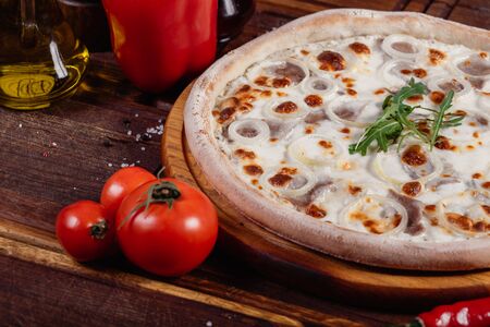 Appetizing Pizza with sliced vegetables on rustic wood, vintage styleの写真素材