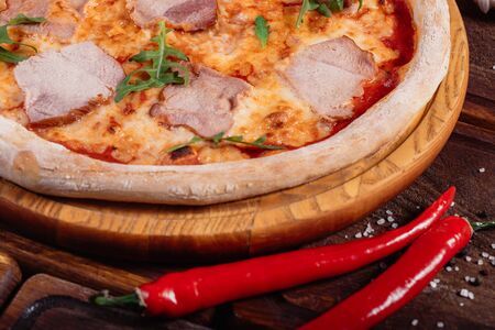 Pizza with sliced vegetables on rustic wood, vintage styleの写真素材