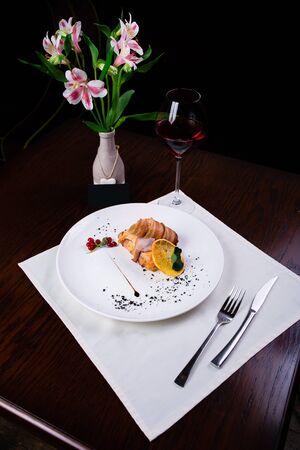 Grilled fillet mignon steak wrapped in bacon, with grilled vegetables, butter and rosemarieの写真素材