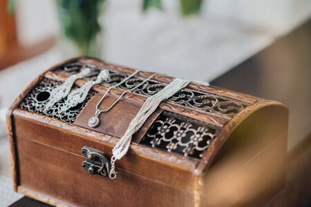 Vintage womens jewelry and gloves. Retro concept with dried roses on a wooden backgroundの写真素材
