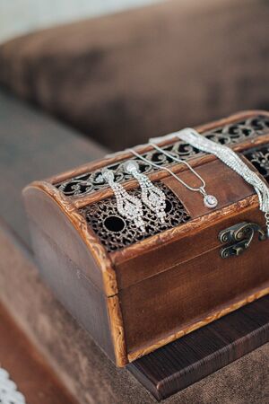 Vintage womens jewelry and gloves. Retro concept with dried roses on a wooden backgroundの写真素材