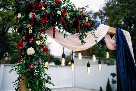 Wedding archway with flowers arranged in park for a wedding ceremony in wedding dayの写真素材