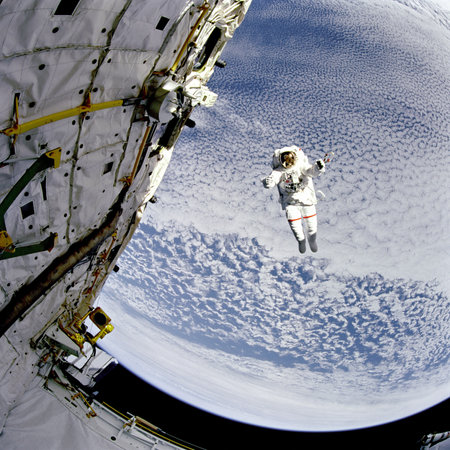 Astronaut in outer space on the background of the planet.