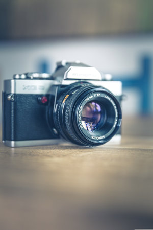 Retro camera on a wooden table. Shallow depth of field