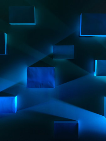 abstract blue cubes on a black background, geometric shapes in the dark