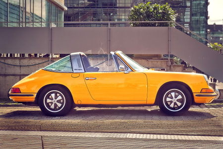 Vintage yellow car in the city. Retro style. Toned.