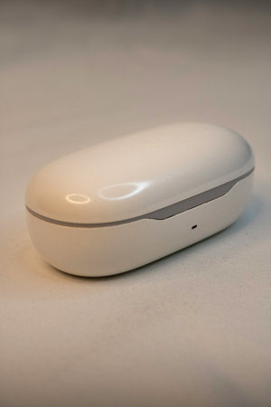 Close-up of a white electronic device on a white background.