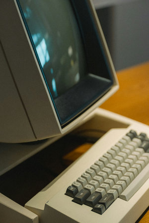 Close-up of a computer monitor with keyboard and mouse on table
