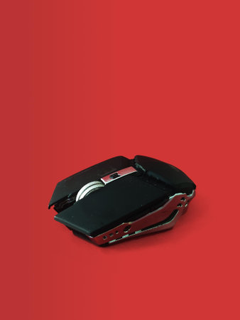 Computer mouse isolated on a red background with copy space.の写真素材