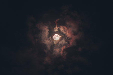 full moon in the dark sky with clouds - retro vintage effect style picturesの写真素材