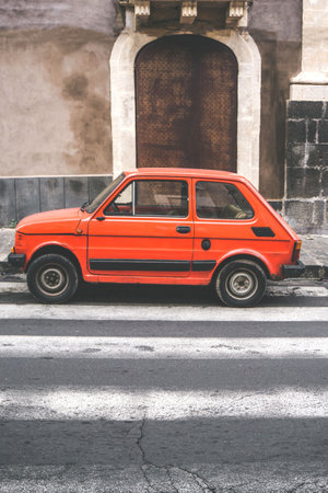 Old red car on the street in Rome, Italy. Retro styleの写真素材