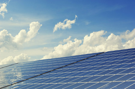 Solar panels against blue sky with white clouds, photovoltaic cellsの写真素材