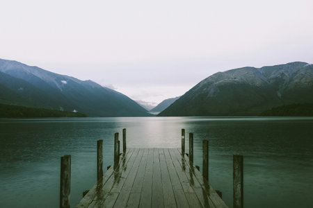 Wooden pier on the lake in the mountains. Toned.の写真素材