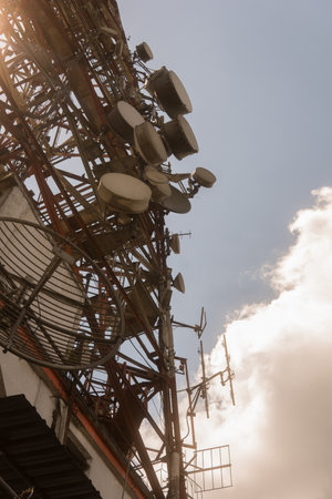 Telecommunication tower with blue sky and white clouds,Vintage style