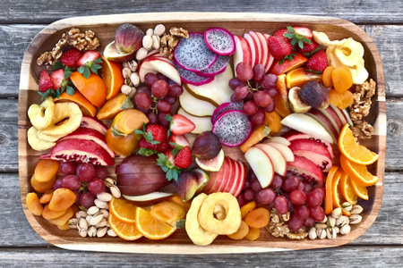 Healthy fruit salad in a wooden box, top view, vertical