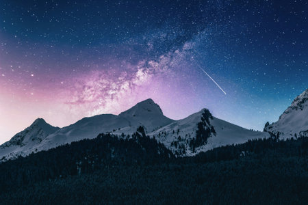 Night starry sky with milky way over mountain peak and forest