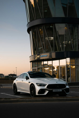Luxury car parked in front of a modern building.
