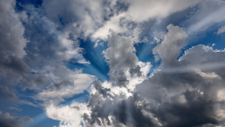 Blue sky with white clouds and sunbeams. Abstract background.の写真素材
