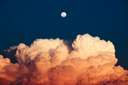 Beautiful sunset sky with clouds and the moon. Natural background.の写真素材