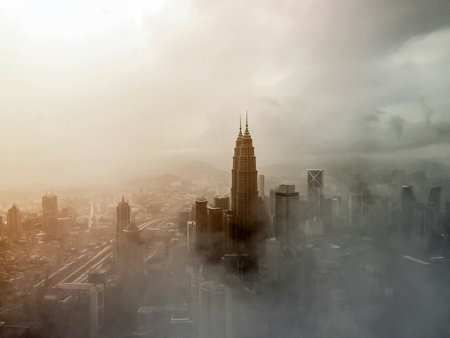 Dramatic view of Kuala Lumpur skyline with fog in Malaysia.の写真素材